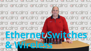 engineer with ethernet switches standing behind table